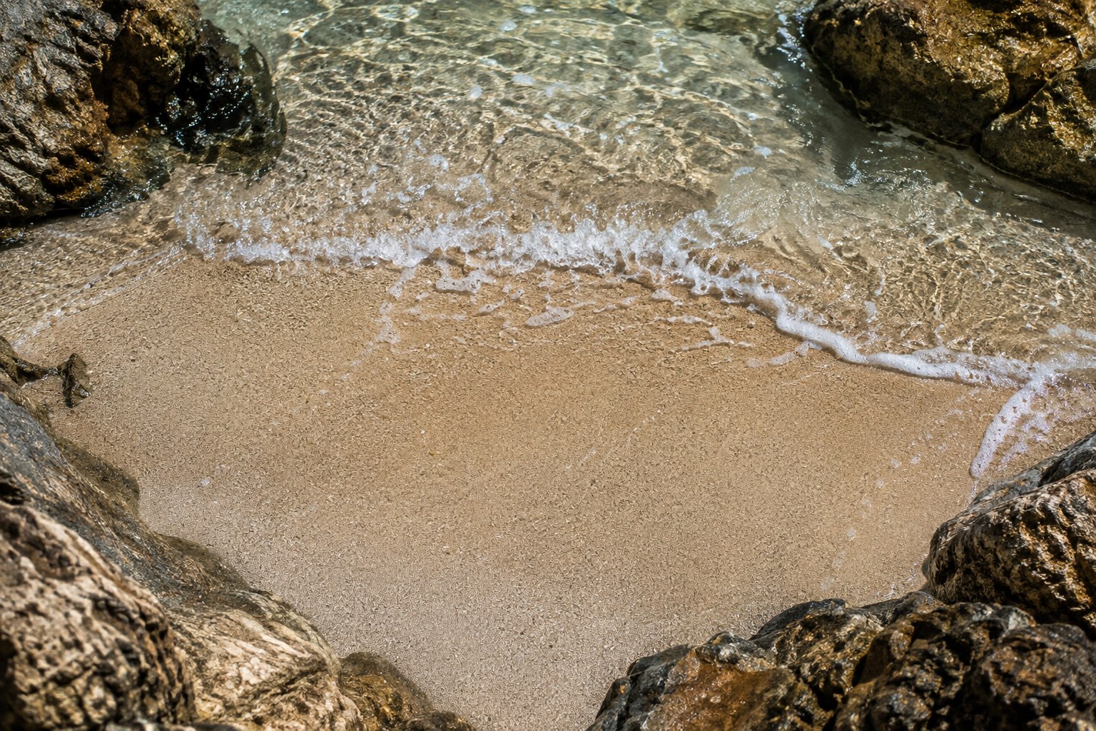 A sandy cove beach beside the sea